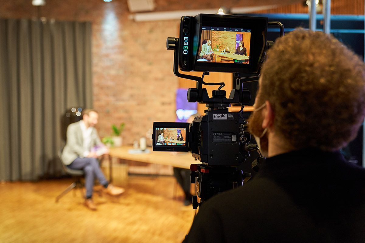 Camera filming an interview at a hybrid event