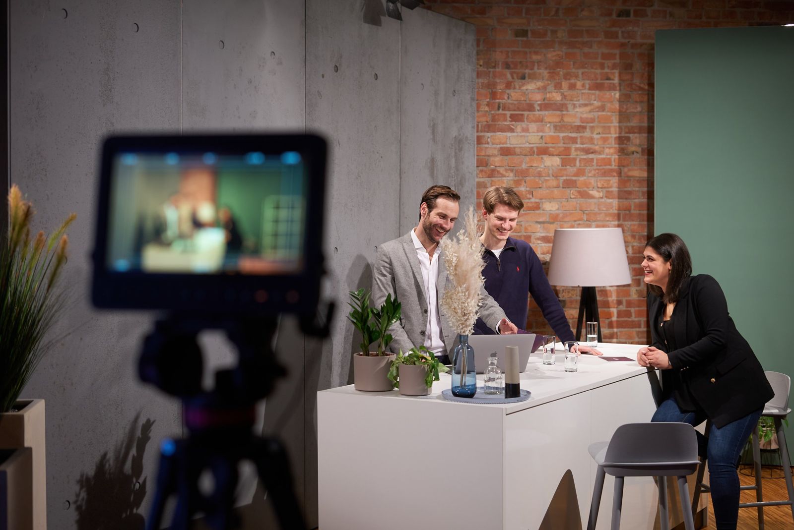 Streaming studio at Spreespeicher with a camera and presenter desk against a brick wall